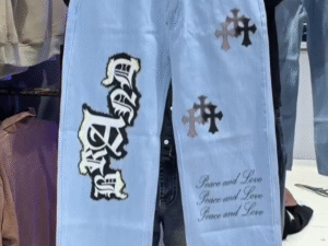 👖✨ Light-Wash Straight-Fit Denim Jeans with Cross & Text Prints – Street Style Essential